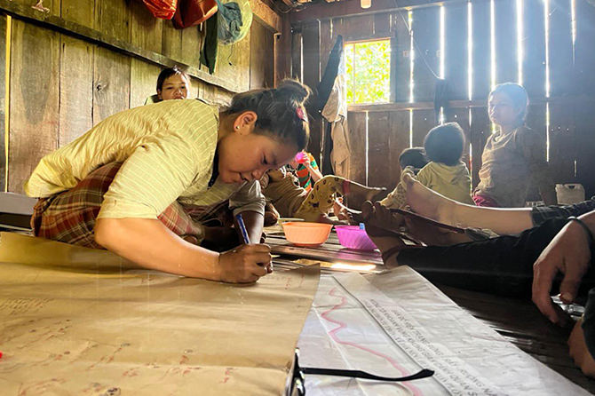 Ca Doong indigenous people, helping out drawing their village maps.